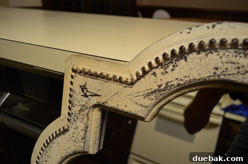 Close-up of the mirror's beaded detail and rustic finish before painting
