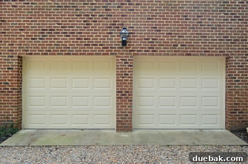 New black lantern above garage doors, appears small