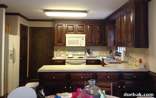 Remove Wallpaper with Soap and Water 12 Another view of the kitchen wall with partially removed wallpaper, focusing on the backsplash area.