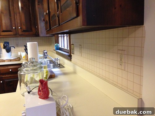 Remove Wallpaper with Soap and Water 13 Close-up showing stubborn wallpaper residue and glue on the kitchen wall, requiring more effort.