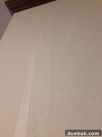 Remove Wallpaper with Soap and Water 14 Detail of wallpaper backing left on the wall, resembling white tiger stripes.