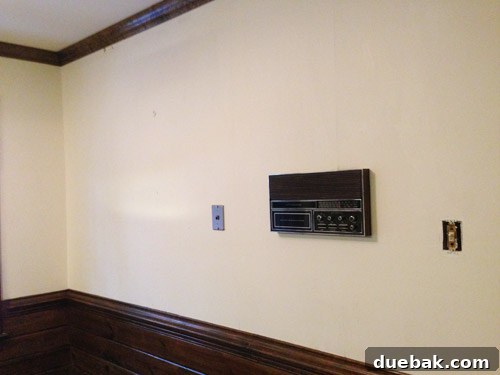 Remove Wallpaper with Soap and Water 3 Clean, wallpaper-free kitchen wall with an intercom after successful removal.