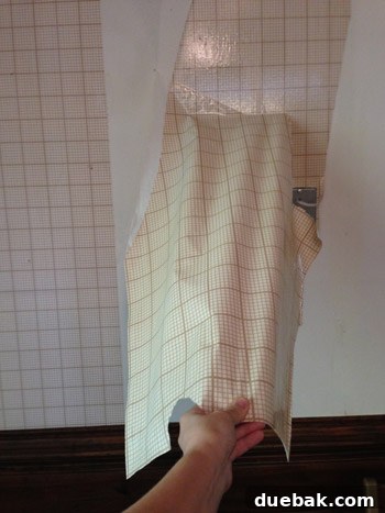 Remove Wallpaper with Soap and Water 6 Large sheets of wallpaper being peeled off a wall, showing successful removal without scoring.