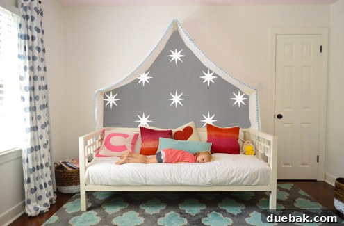 Photoshop mockup: Clara's room with a freehand, painterly-style wall mural above the canopy.