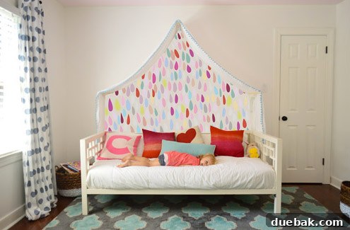 Photoshop mockup: Clara's room with a blue-green wall featuring small bird motifs above the canopy.