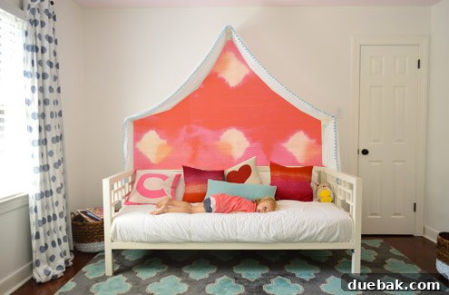 Photoshop mockup: Clara's room with a dark charcoal painted wall and asymmetrical handmade banners above the canopy.