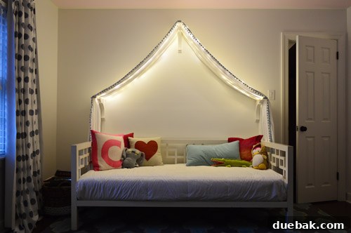 Clara's bed with the canopy and fairy lights, showing the space above the canopy that needs further decoration.