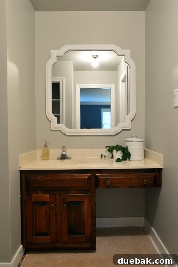 Revere Pewter: The Gray Paint Everyone Raves About 10 Bathroom mirror reflecting a wall painted with Benjamin Moore Revere Pewter