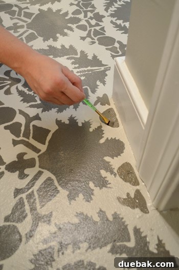 Design Your Dream Floor with Stencils 18 Close-up of the floor edge showing a small unpainted gap next to the baseboard