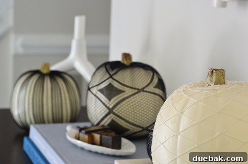 Pumpkins Transformed: The Pantyhose Touch 2 Elegant black fishnet stocking covering a large white faux pumpkin, creating a sophisticated and spooky spiderweb-like Halloween decoration.