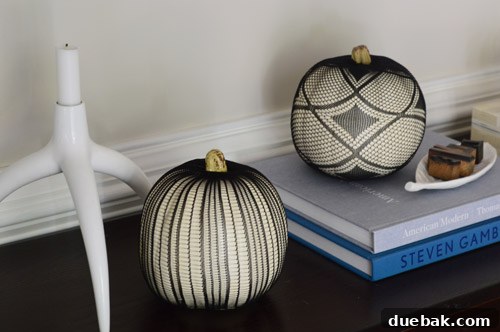 Pumpkins Transformed: The Pantyhose Touch 6 A finished faux pumpkin adorned with a black fishnet stocking, neatly trimmed and secured around the stem, showcasing the intricate web-like pattern.