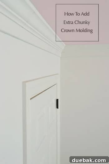 Chunky double-wide crown molding installed in a room with a pink ceiling