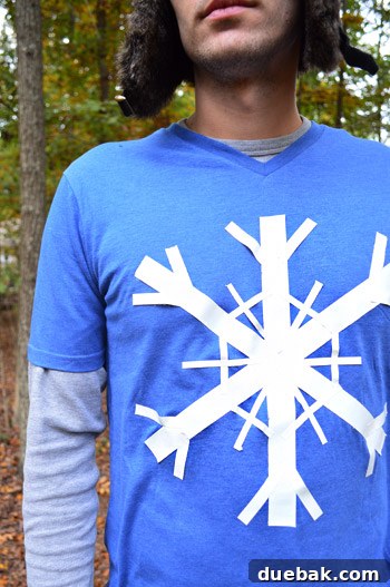 John in his blue t-shirt with the duct tape snowflake, looking at his reflection.