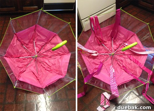 Inside view of the DIY jellyfish costume, showing pink tissue paper in umbrella panels and fabric ribbons tied to the spines.