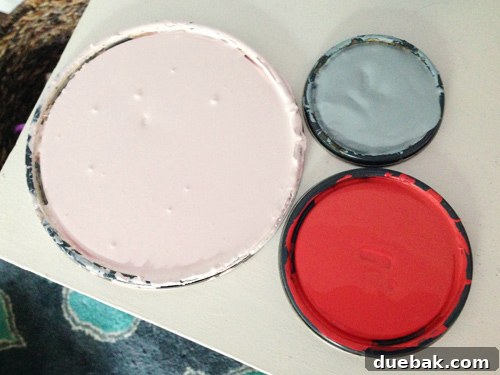 Open Paint Cans Of Three Colors For Raindrop Wall | Pink Cadillac | Tranquil | Cinco De Mayo - Three open paint cans with pink, blue (Tranquil), and red (Cinco De Mayo) colors for the raindrop mural.