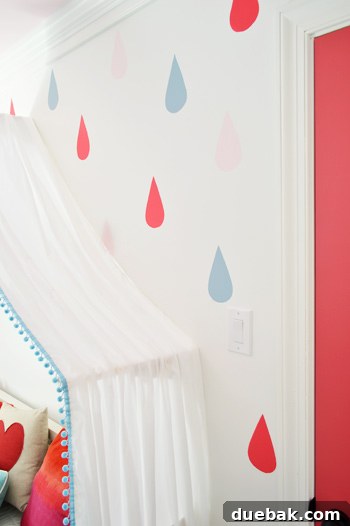 Close Up Of Painted Colorful Raindrop Wall Mural In Girls Bedroom - A detailed close-up of the hand-painted colorful raindrop mural in a girl's bedroom, showcasing the varied colors and organic placement.