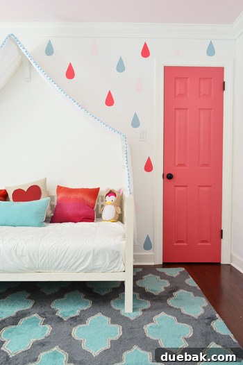 Dark Pink Closet Door Cinco De Mayo Benjamin Moore With Raindrop Mural - A close-up of the finished dark pink closet door in Benjamin Moore's Cinco De Mayo, alongside the colorful raindrop mural.