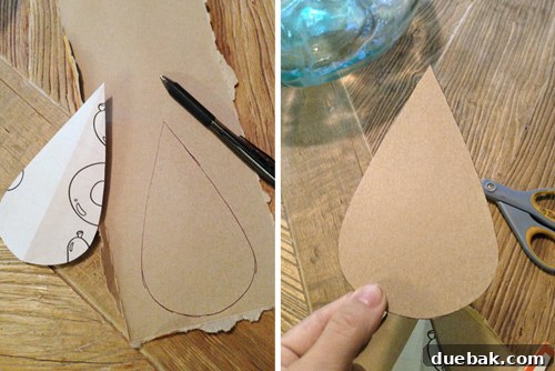 Cutting Out Template For Raindrop Mural Shape Using Cardboard - Demonstrating how to cut a cardboard stencil for the raindrop mural.