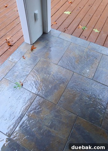 Outdoor tiles showing dried thinset splotches and haze after a week of rain