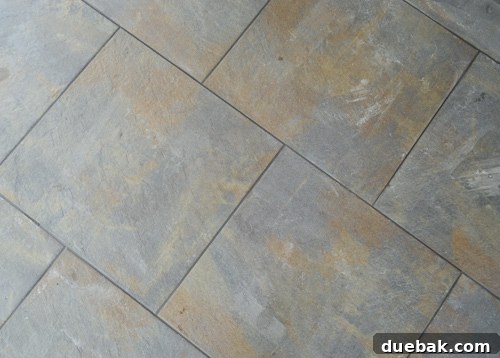 Closer look at the charcoal grout lines in the outdoor tiled floor, highlighting the rich color
