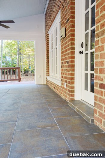 A wider view of the newly tiled sunroom floor, highlighting the spacious and renovated area