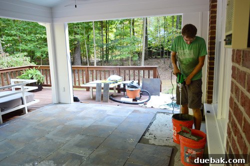 Newly tiled outdoor floor with slate-like porcelain tiles and a decorative border