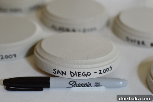 Labeling painted wood plaques with destination and year using Sharpie