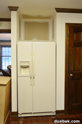How to Remove and Rehang Kitchen Cabinets 11 DIYer using a circular saw to trim the face of a kitchen cabinet with tape applied