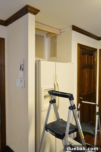 How to Remove and Rehang Kitchen Cabinets 13 Kitchen upper cabinet reinstalled above fridge, flush with the wall