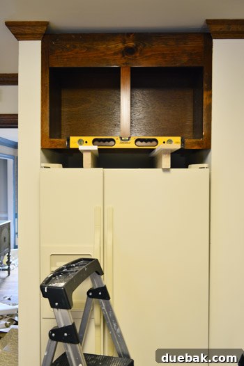 How to Remove and Rehang Kitchen Cabinets 14 Close-up of newly reinstalled crown molding in a kitchen