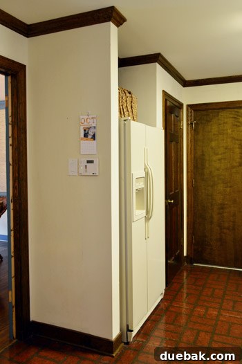 How to Remove and Rehang Kitchen Cabinets 16 Kitchen wall with window, showing removed cabinets and reinstalled crown molding, awaiting paint and shelves