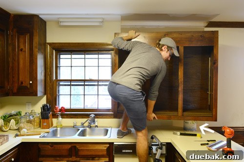 How to Remove and Rehang Kitchen Cabinets 6 Large kitchen cabinet removed, showing unpainted wall behind it