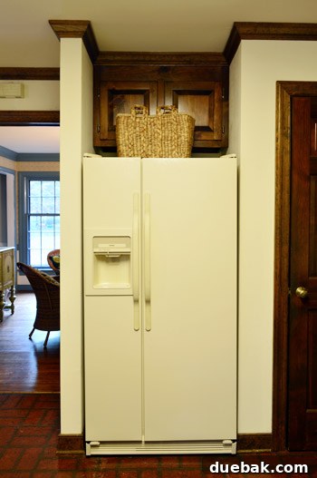 How to Remove and Rehang Kitchen Cabinets 9 Kitchen fridge with a deep, inaccessible upper cabinet above it