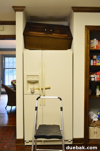 How to Remove and Rehang Kitchen Cabinets 10 Upper fridge cabinet half-pulled out, revealing drywall damage