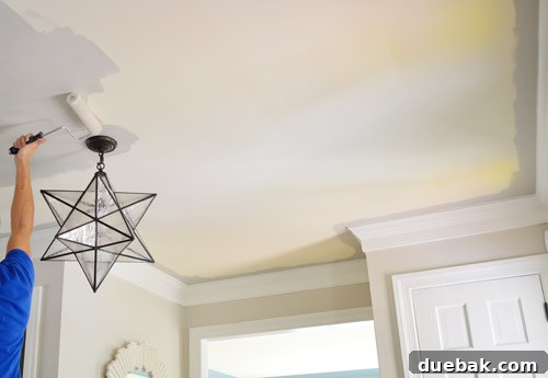 Foyer ceiling being painted a darker gray with Benjamin Moore Revere Pewter