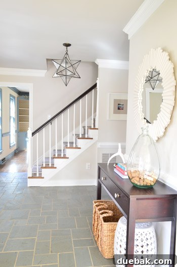 Foyer featuring a thoughtfully contrasted gray ceiling painted with Benjamin Moore Revere Pewter