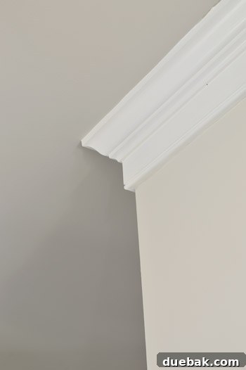 Detailed view of the Benjamin Moore Revere Pewter ceiling, Benjamin Moore Simply White trim, and Benjamin Moore Edgecomb Gray walls in the foyer
