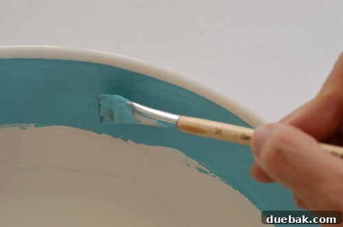 Painting the inner lip of the bowl
