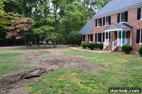 Curb Appeal Mastery 3 Uneven front yard after initial leveling, showing pooling water