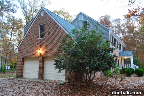Our garage doors and exterior, with a small light fixture above, ready for a major overhaul.