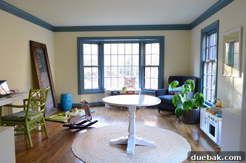 The office with old curtains and wood floors, awaiting a complete functional and aesthetic redesign.