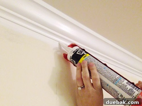 Close-up of newly painted white trim, highlighting the importance of caulking cracks