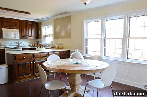 Close-up of the bright kitchen, highlighting the freshly painted white surfaces
