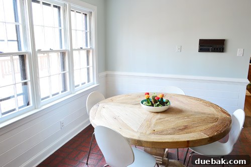 Serene Blue-Gray for Kitchen Walls 23 Breakfast area with white trim, horizontal planking, and new blue walls, showing its potential despite the old intercom and fake brick floor.