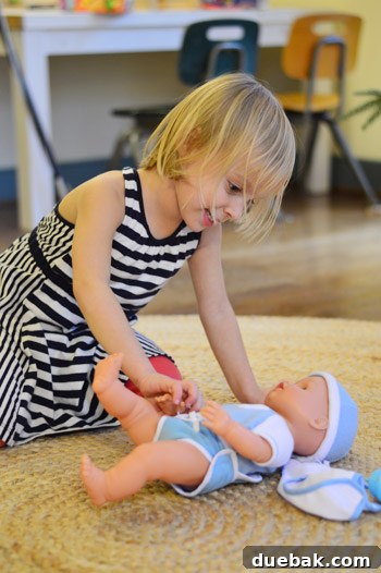 Clara joyfully playing with her new baby boy doll
