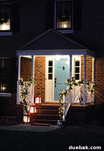 Effortless Window Wreath Styling 16 Our house exterior fully decorated for Christmas, showcasing all the elements combined – wreaths, garland, lanterns, and window candles – creating a festive and welcoming holiday display.