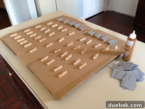 Get Crafting 4 DIY Holiday Decorations 12 Glueing gray paper light socket cut outs onto clothespin for Christmas craft garland