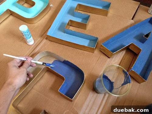Get Crafting 4 DIY Holiday Decorations 17 Painting inside of cardboard craft letter with blue gradient paint