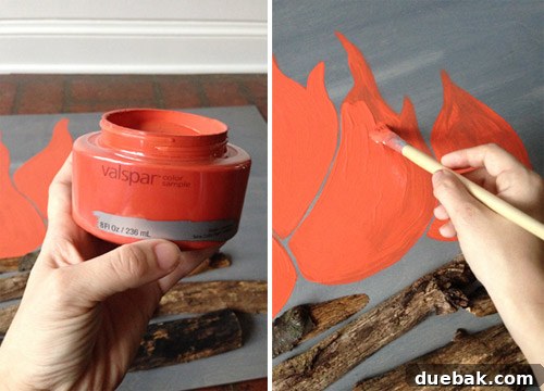 Get Crafting 4 DIY Holiday Decorations 7 Sherry painting fake flames on DIY faux holiday fireplace
