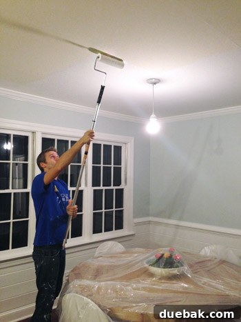Upgrade Your Lighting: Swapping Fluorescent Fixtures for Pendants 20 John painting ceiling with roller